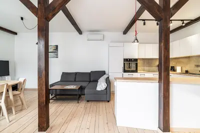 a living room with a couch and a table at RentPlanet - Apartament przy Plantach in Kraków