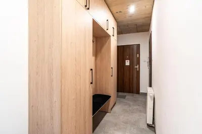 a hallway with wooden lockers in a building at RentPlanet - Apartament przy Plantach in Kraków