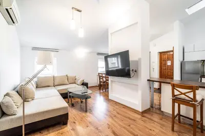 a living room with a couch and a flat screen tv at RentPlanet - Apartament przy Plantach in Kraków