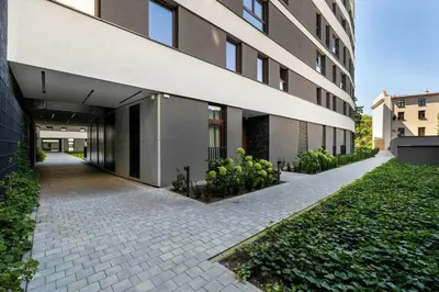 a building with a sidewalk in front of a building at Cosy Apartment in Cracow with Parking, Desk and Balcony by Noclegi Renters in Kraków
