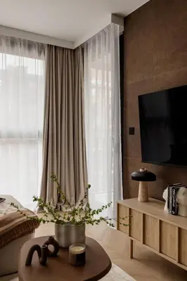 a living room with a large window and a tv at High Line by A11 in Kraków