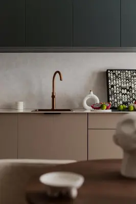 a kitchen counter with a sink and a bowl of fruit at High Line by A11 in Kraków