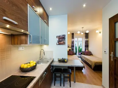 a kitchen with a bowl of fruit on a counter at Vanilla 2, 3bdr 2bth apartment 5min to Main Square in Kraków