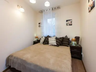 a bedroom with a large bed and a window at Vanilla 2, 3bdr 2bth apartment 5min to Main Square in Kraków
