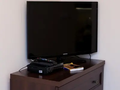 a flat screen tv sitting on top of a dresser at Vanilla 2, 3bdr 2bth apartment 5min to Main Square in Kraków