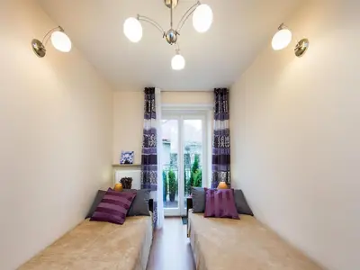 a room with two beds and a window at Vanilla 2, 3bdr 2bth apartment 5min to Main Square in Kraków