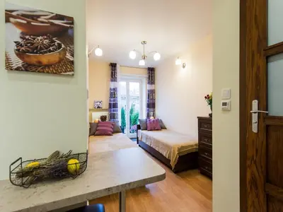a living room with a couch and a bed in a room at Vanilla 2, 3bdr 2bth apartment 5min to Main Square in Kraków