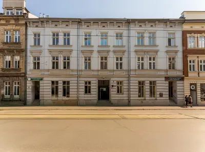 a bedroom with a large bed and a mirror at Starowiślna Harmony Apartment by BookingHost in Kraków