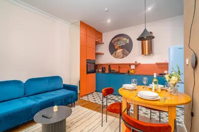 a living room with a blue couch and a table at Bosacka Apt - Top Location, Old Town nearby - by Rentujemy in Kraków