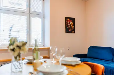 a living room with a table and a blue couch at Bosacka Apt - Top Location, Old Town nearby - by Rentujemy in Kraków