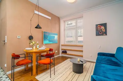 a living room with a table and a blue couch at Bosacka Apt - Top Location, Old Town nearby - by Rentujemy in Kraków