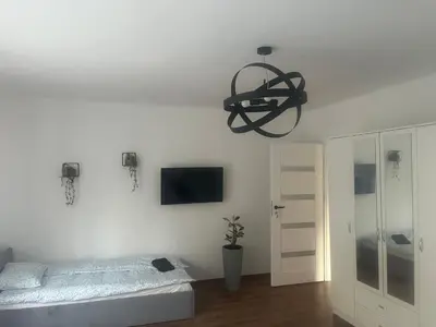 a bedroom with a bed and a chandelier at u Wiktorii in Sąspów