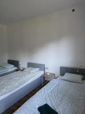 a room with three beds and two tables at u Wiktorii in Sąspów