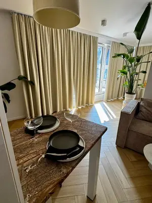 a living room with a table with plates on it at Piltza House in Kraków