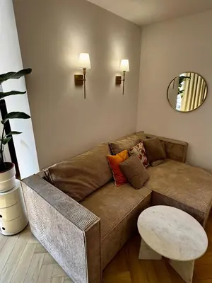 a living room with a brown couch and a table at Piltza House in Kraków