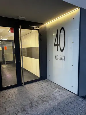 a door with the number on the side of a building at Piltza House in Kraków