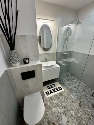 a bathroom with a toilet and a sink and a mirror at Piltza House in Kraków