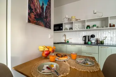 a kitchen with a wooden table with fruit on it at Central Luminis Comfort Kraków 2 in Kraków