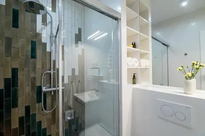 a bathroom with a glass shower and a sink at Central Luminis Comfort Kraków 2 in Kraków