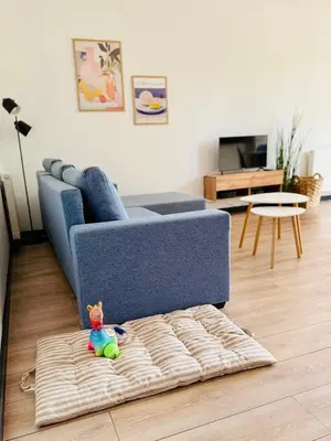 a blue couch in a living room with a toy at Best Rest Kraków in Kraków