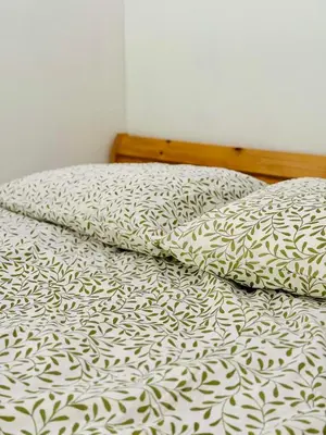 a bed with a black and white comforter and pillows at Best Rest Kraków in Kraków