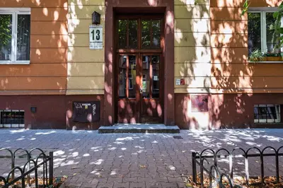 a building with a door with a sign on it at Apartament Green Old Town Krakow in Kraków