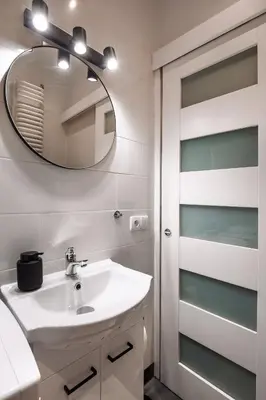 a bathroom with a sink and a mirror at Apartament Green Old Town Krakow in Kraków