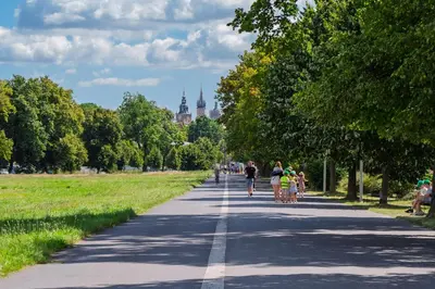 a group of people walking down a road at Apartament Green Old Town Krakow in Kraków