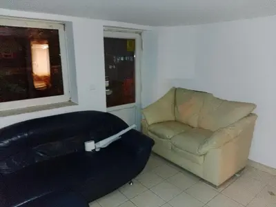 a living room with a couch and a chair at Budget & Cosy APART in Kraków