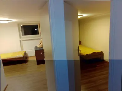 an empty room with two beds and a window at Budget & Cosy APART in Kraków