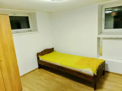 a room with a bed with a yellow sheet on it at Budget & Cosy APART in Kraków
