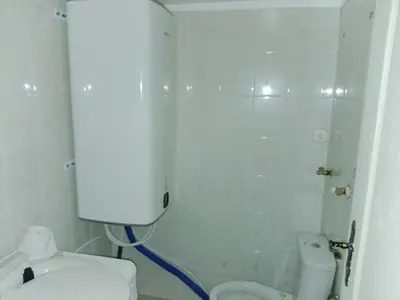 a small bathroom with a toilet and a shower at Budget & Cosy APART in Kraków