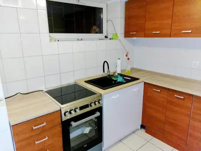 a kitchen with a sink and a stove at Budget & Cosy APART in Kraków