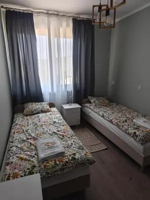 a bedroom with two beds and a window at Chatka Przytulasek in Męcina