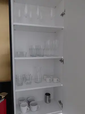 a refrigerator filled with lots of glasses and cups at Apartment Cracow Old Town in Kraków