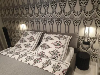 a bed with two pillows on top of it at Apartment Cracow Old Town in Kraków