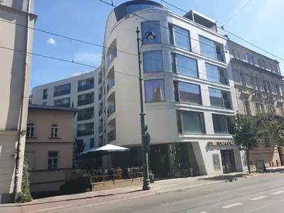 a building on a street with a table in front of it at Apartment Cracow Old Town in Kraków