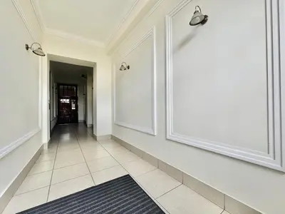 a hallway with white walls and a tile floor at GREEN APARTMENTS #Kazimierz, building C in Kraków
