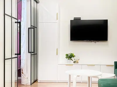 a living room with a tv on a wall at Premium & Quiet Apartment next to Main Square in Kraków