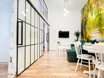 a living room with a green couch and a table at Premium & Quiet Apartment next to Main Square in Kraków