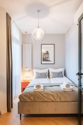 a bedroom with a bed with two towels on it at Wawel z Balkonu - Apartament Premium, bezpłatny parking, szybkie Wifi in Kraków