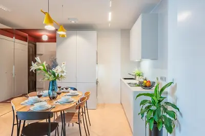 a kitchen and dining room with a table and chairs at Wawel z Balkonu - Apartament Premium, bezpłatny parking, szybkie Wifi in Kraków