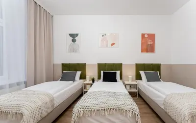 two beds sitting next to each other in a room at Hala Targowa Apartments in Kraków