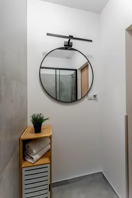 a bathroom with a mirror on the wall at Hala Targowa Apartments in Kraków
