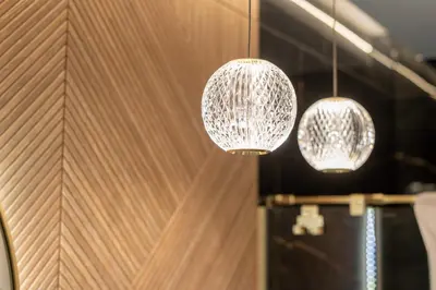 three lights hanging from a wooden wall at Osiedle Willowe Vintage Chic Apartment by BookingHost in Kraków