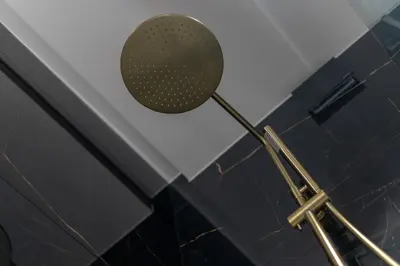 a shower head in the corner of a bathroom at Osiedle Willowe Vintage Chic Apartment by BookingHost in Kraków