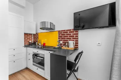 a kitchen with a sink and a stove top oven at Morsztynowska Studio with Mezzanine by BookingHost in Kraków