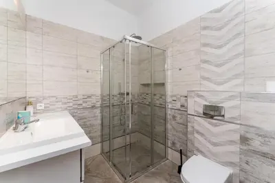 a bathroom with a shower and a sink and a toilet at Morsztynowska Studio with Mezzanine by BookingHost in Kraków