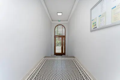 a hallway with a door and a tiled floor at Morsztynowska Studio with Mezzanine by BookingHost in Kraków