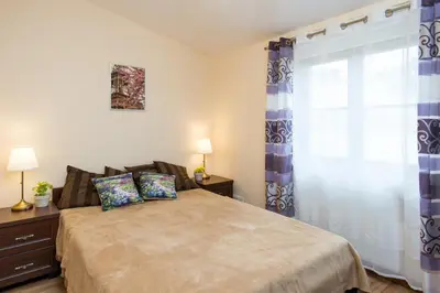a bedroom with a bed and a window with curtains at Vanilla Apartments - 3 spacious apartments 5min to Main Square in Kraków